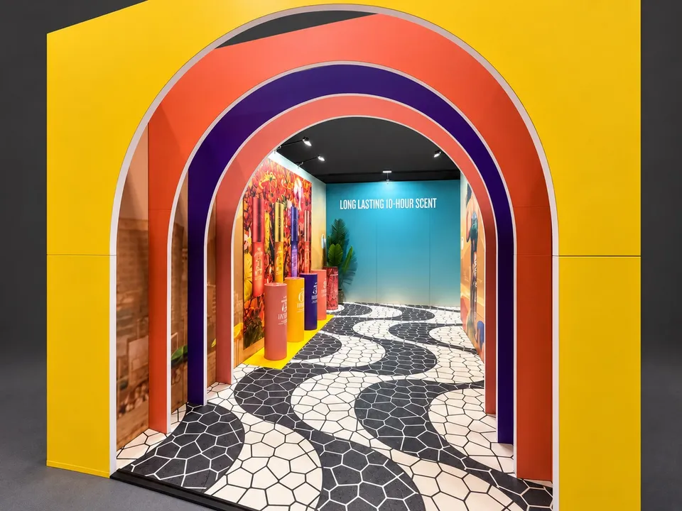 Close view through the exhibition entrance showing the layered coloured arches