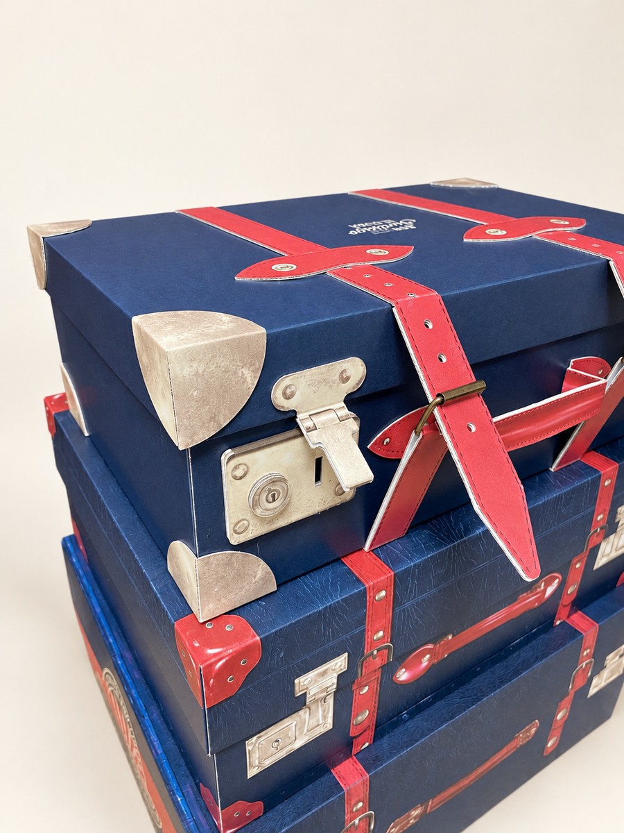 Don Papa suitcase-shaped display with printed straps and corner details