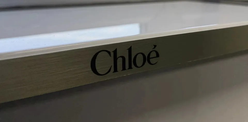 Chloé branding on the front edge of the counter plinth