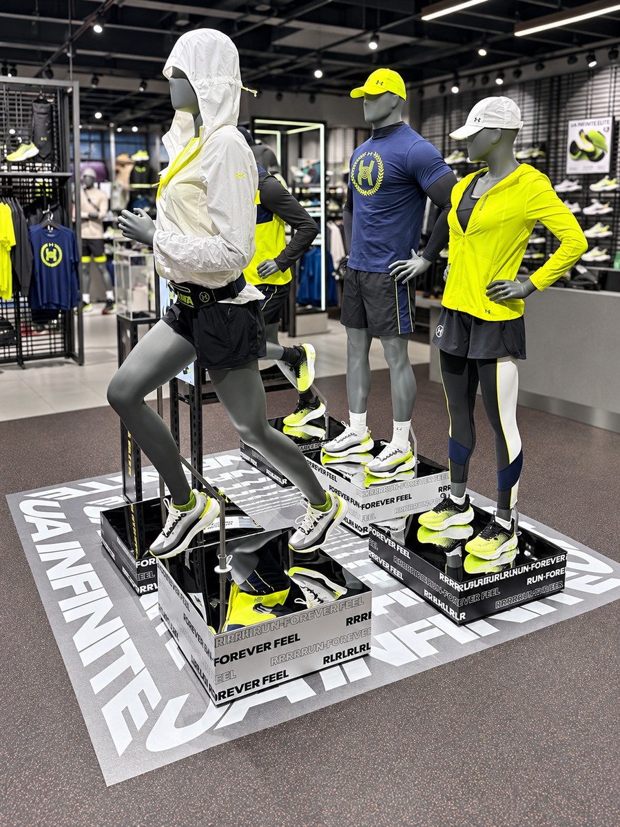 Under Armour campaign graphics around mannequin display platforms