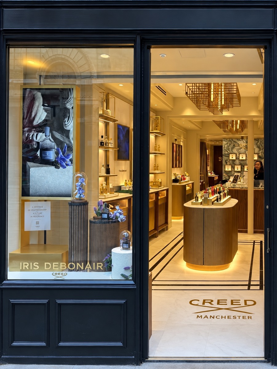 Textured back-wall panels within the Creed retail setting