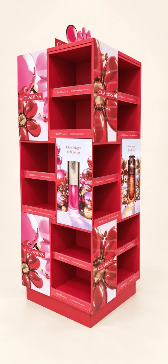 Clarins printed campaign display with pink graphic panels