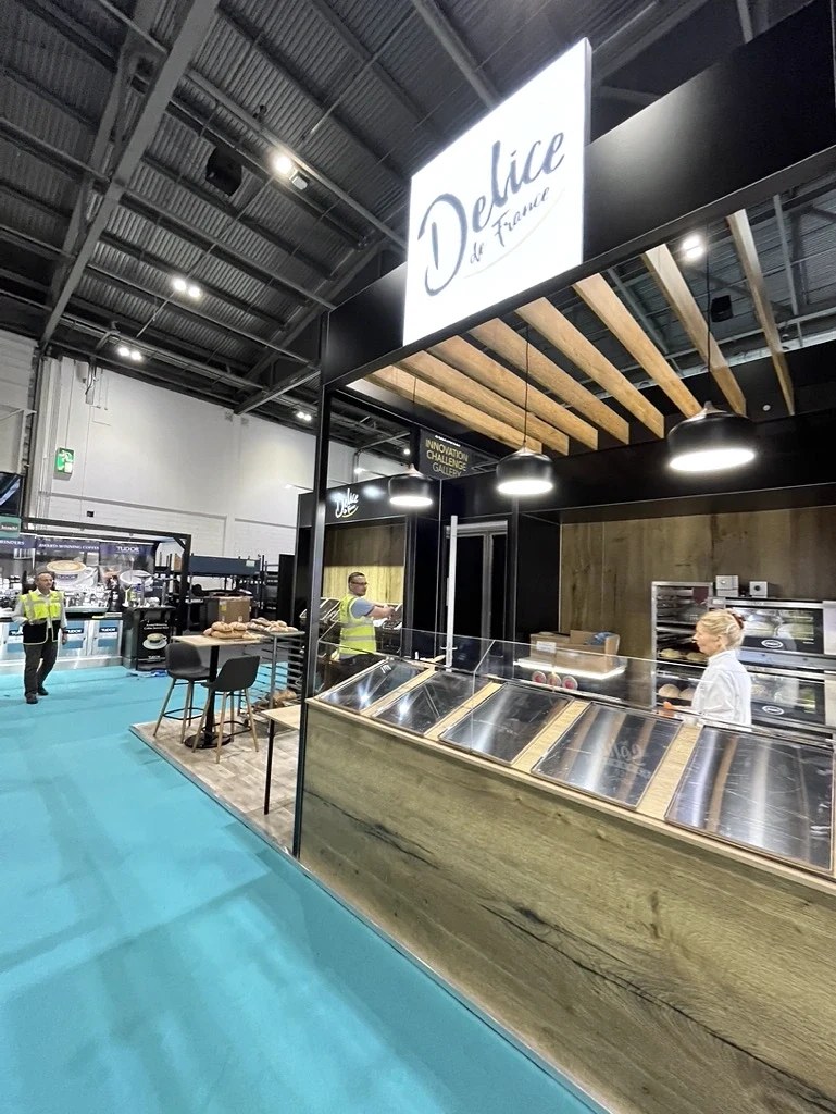 Délifrance exhibition stand with overhead branding and product counter