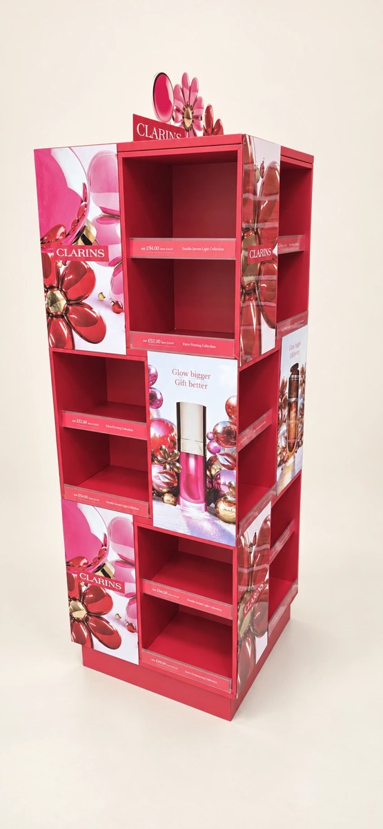 Clarins printed campaign display with pink graphic panels