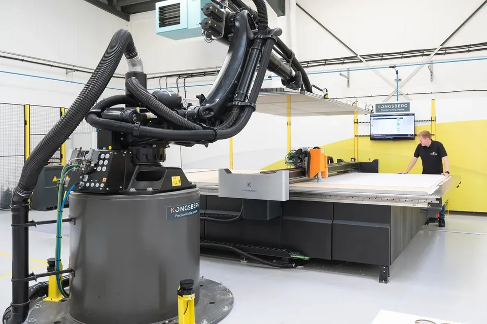 Robotic sheet handling beside a production cutting table
