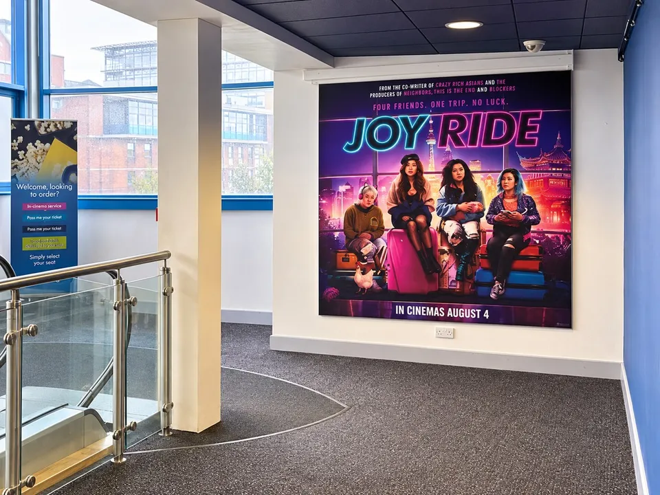 Large-format film campaign graphics within a cinema setting