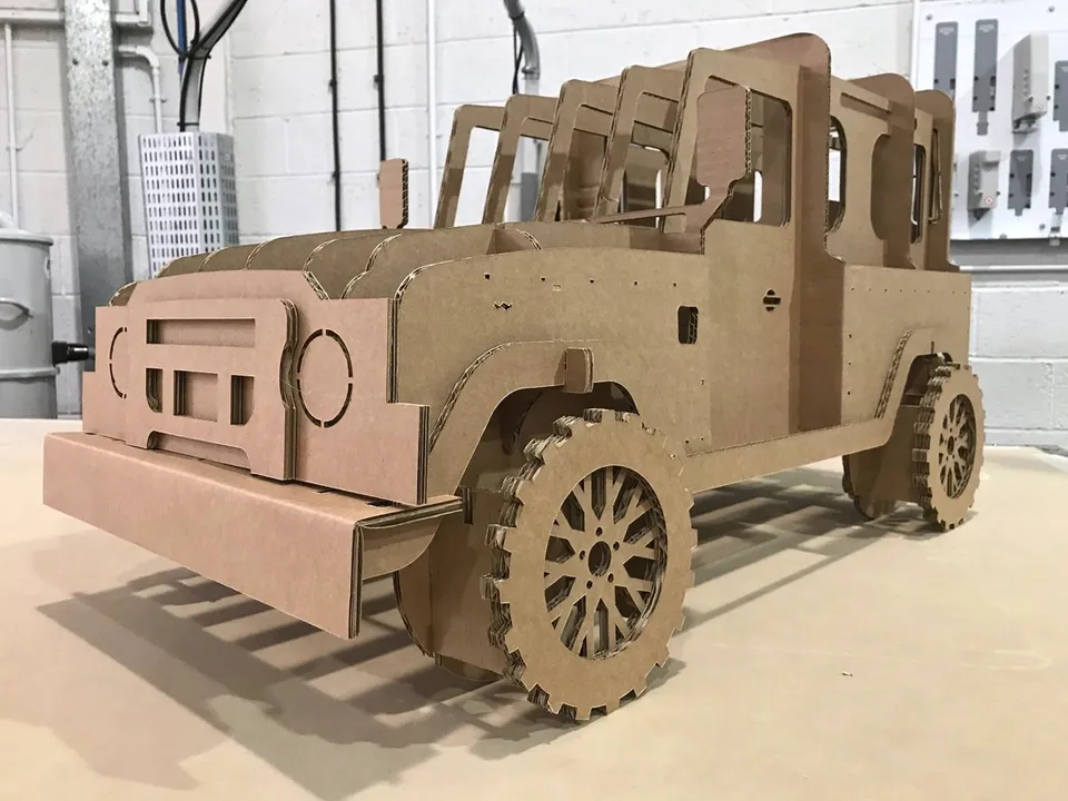 Vehicle replica with cut board profiles and layered wheels
