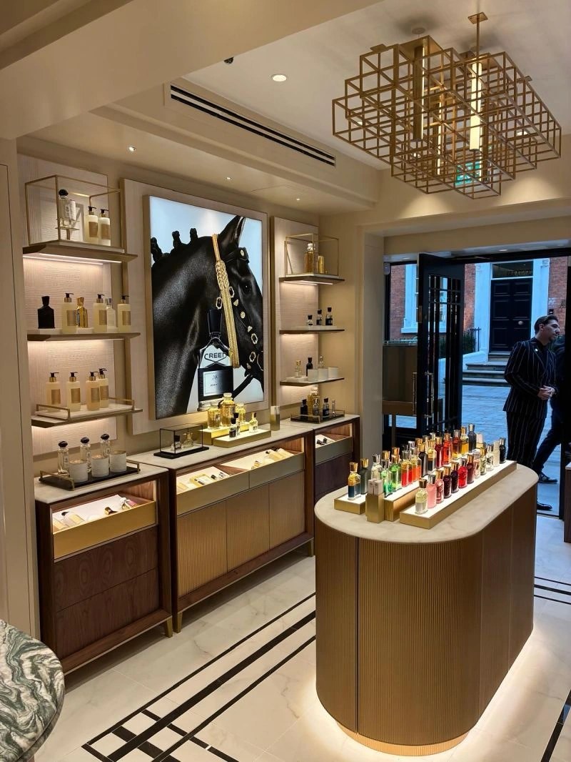 Textured back-wall panels within the Creed retail setting