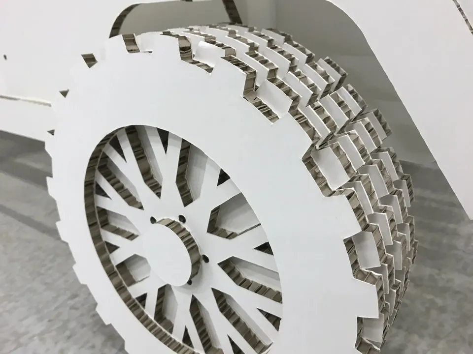 Vehicle replica with cut board profiles and layered wheels