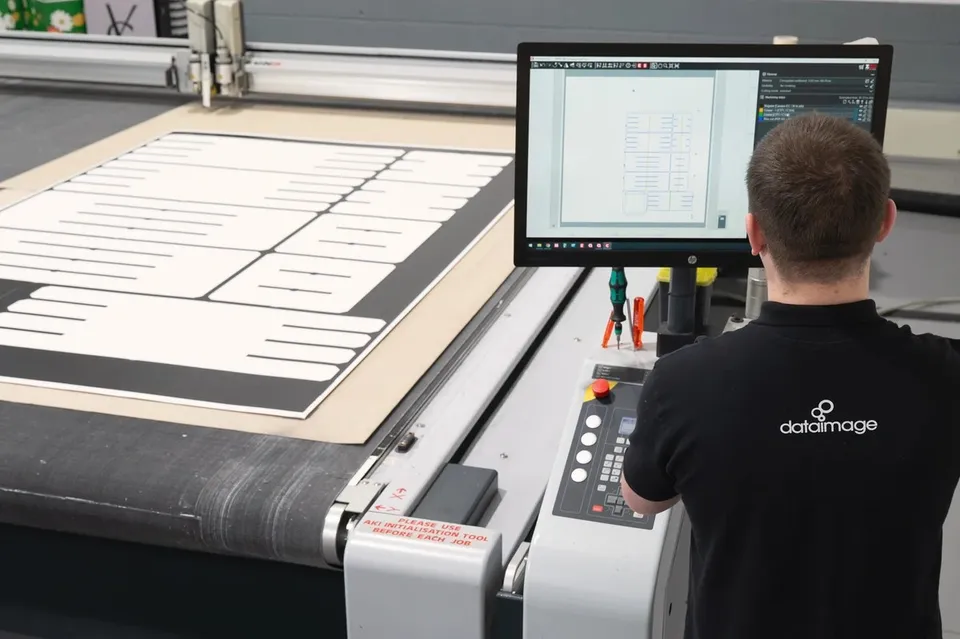 Digital cutting table and operator preparing display components