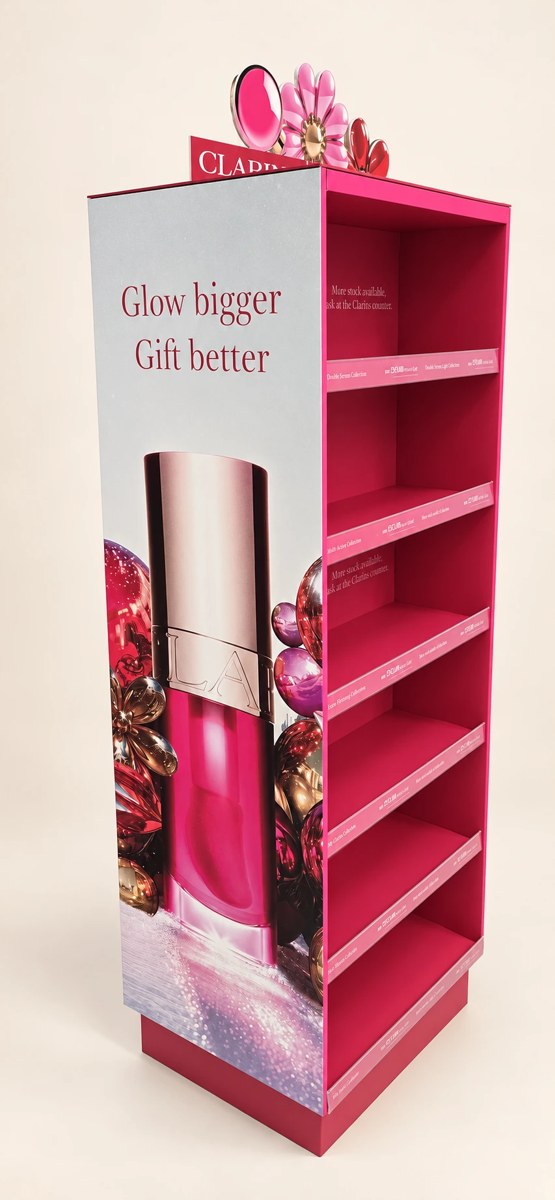 Clarins printed campaign display with pink graphic panels