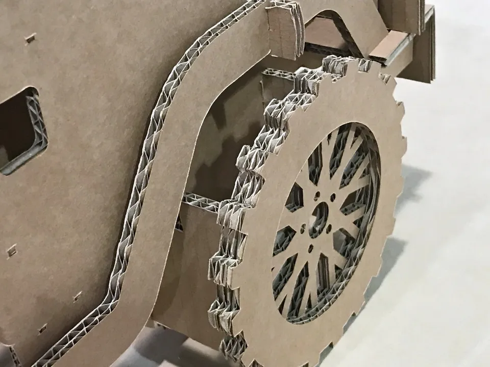 Vehicle replica with cut board profiles and layered wheels