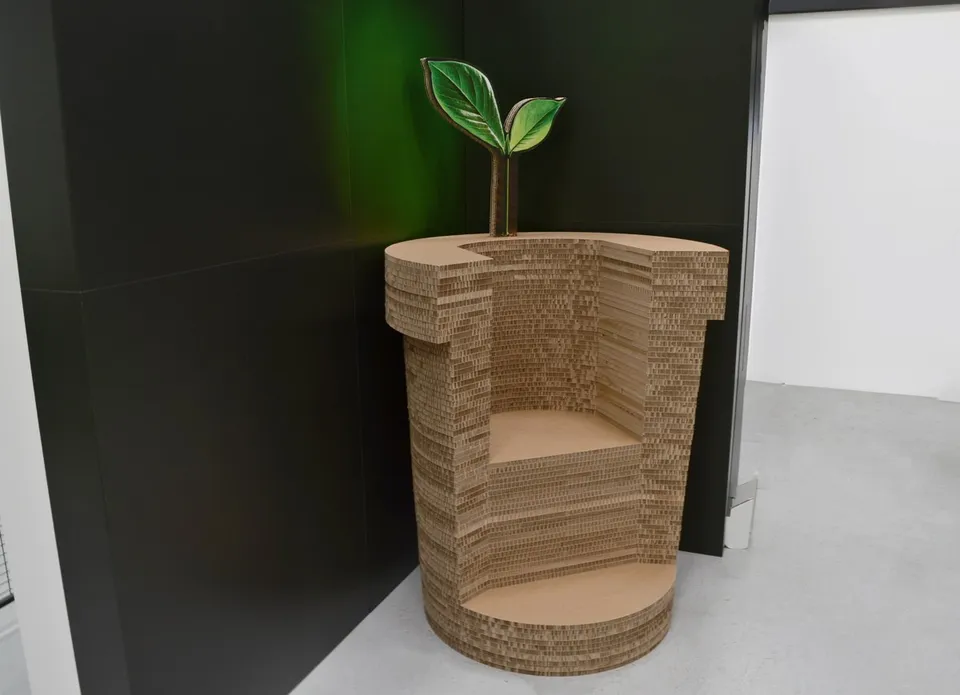 Sculptural chair made from layered board with a decorative leaf