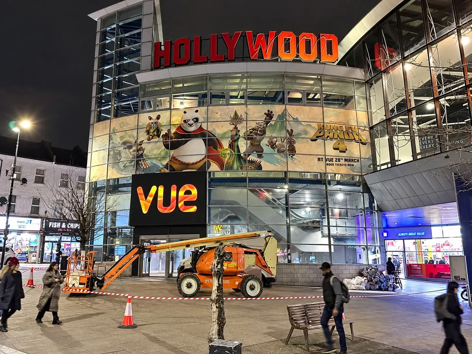 Large-format film campaign graphics within a cinema setting