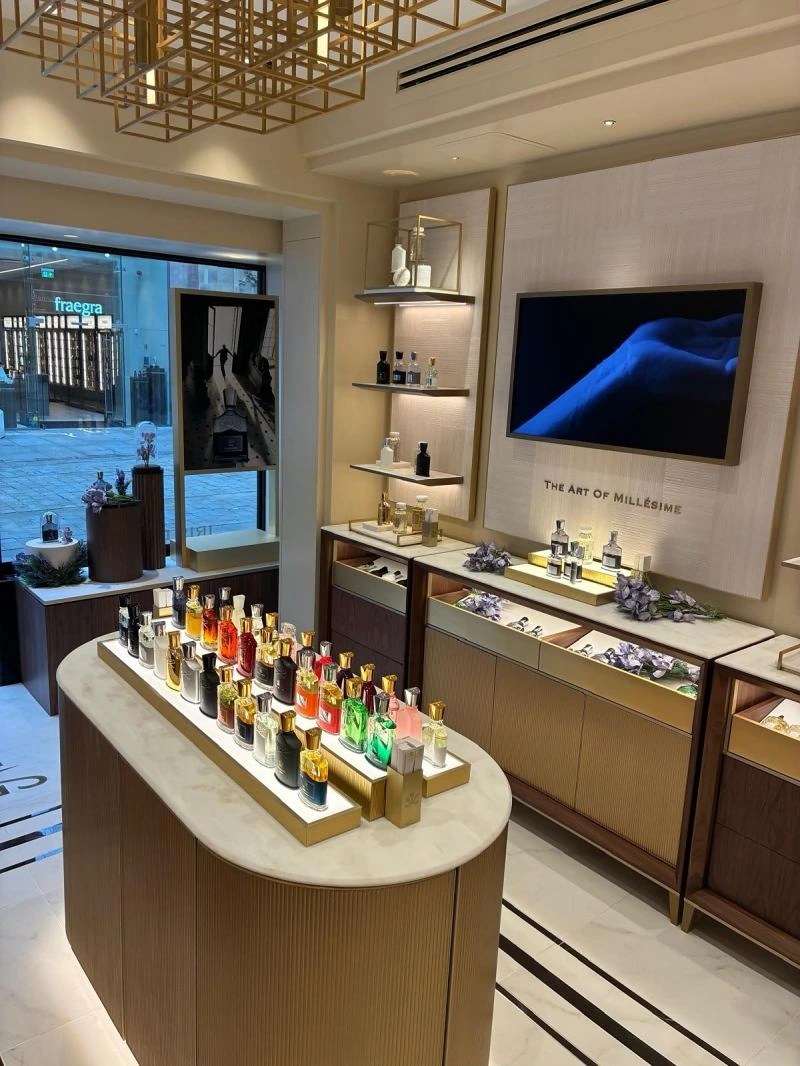 Textured back-wall panels within the Creed retail setting