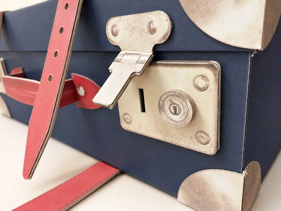 Don Papa suitcase-shaped display with printed straps and corner details