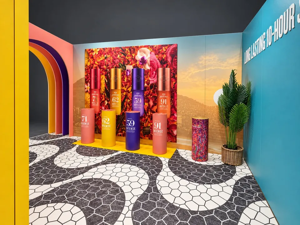 Sol de Janeiro campaign walls and coloured product plinths inside the exhibition stand