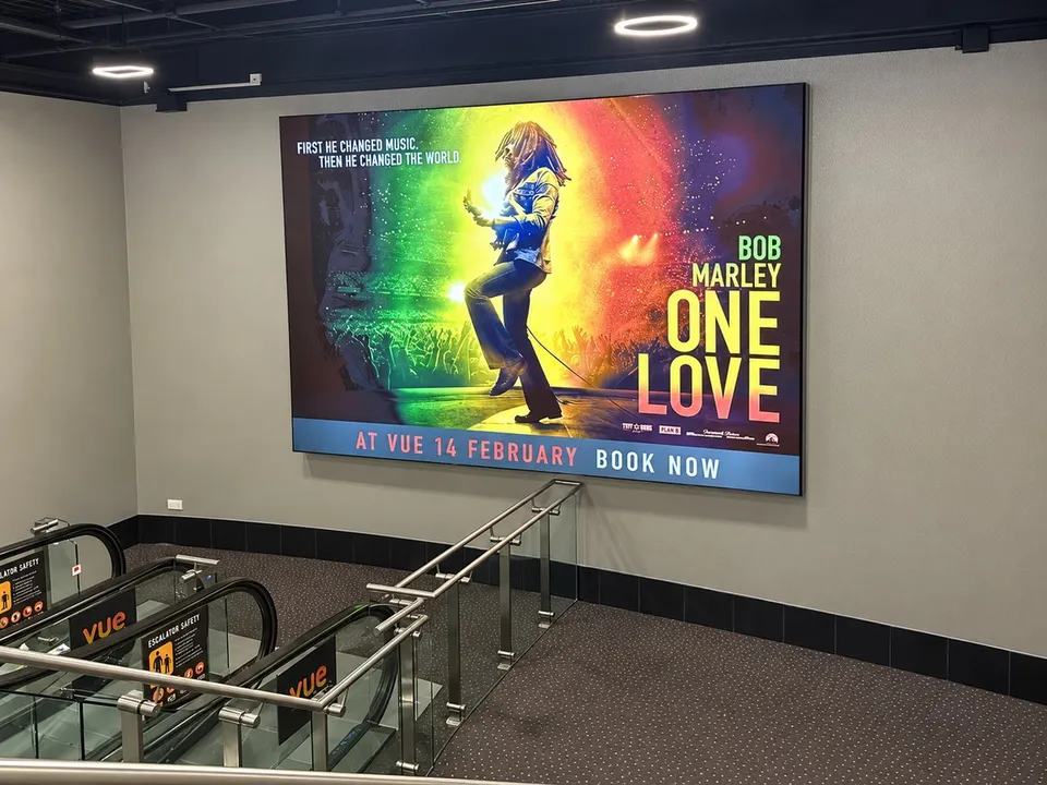 Large-format film campaign graphics within a cinema setting