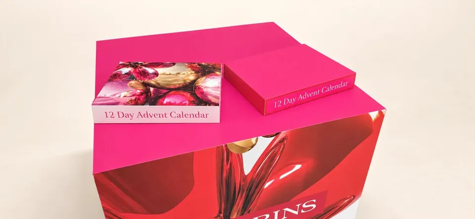 Clarins printed campaign display with pink graphic panels
