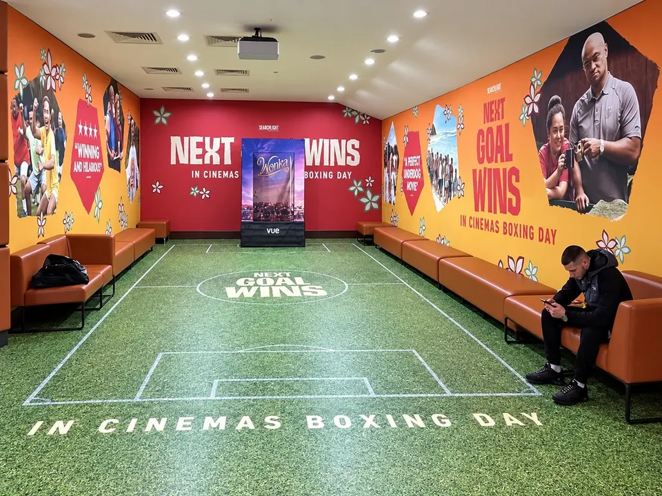 Large-format film campaign graphics within a cinema setting