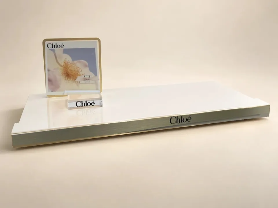 Chloé fragrance counter display with raised plinth and campaign panel