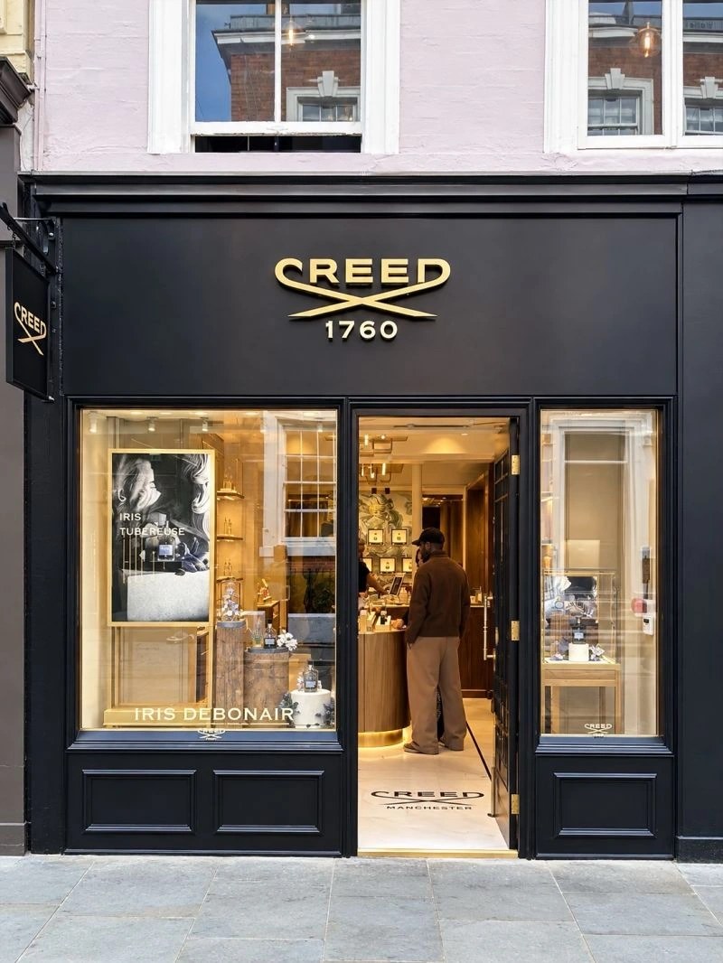 Textured back-wall panels within the Creed retail setting